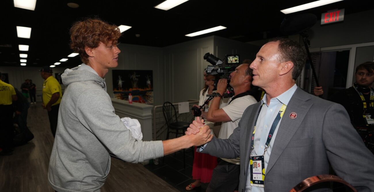 Gavin Ziv (right) shakes hands with Jannik Sinner in the player lounge.