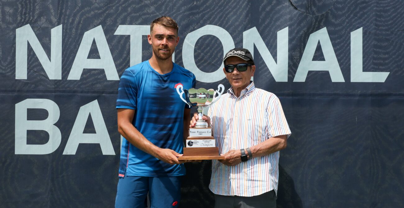 Benjamin Bonzi (right) holds up the trophy at the Winnipeg Challenger.