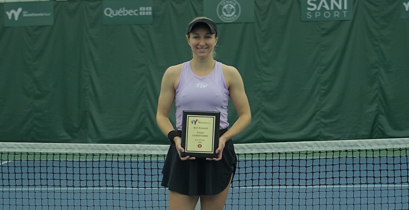 Catherine Harrison holds the Brossard trophy.