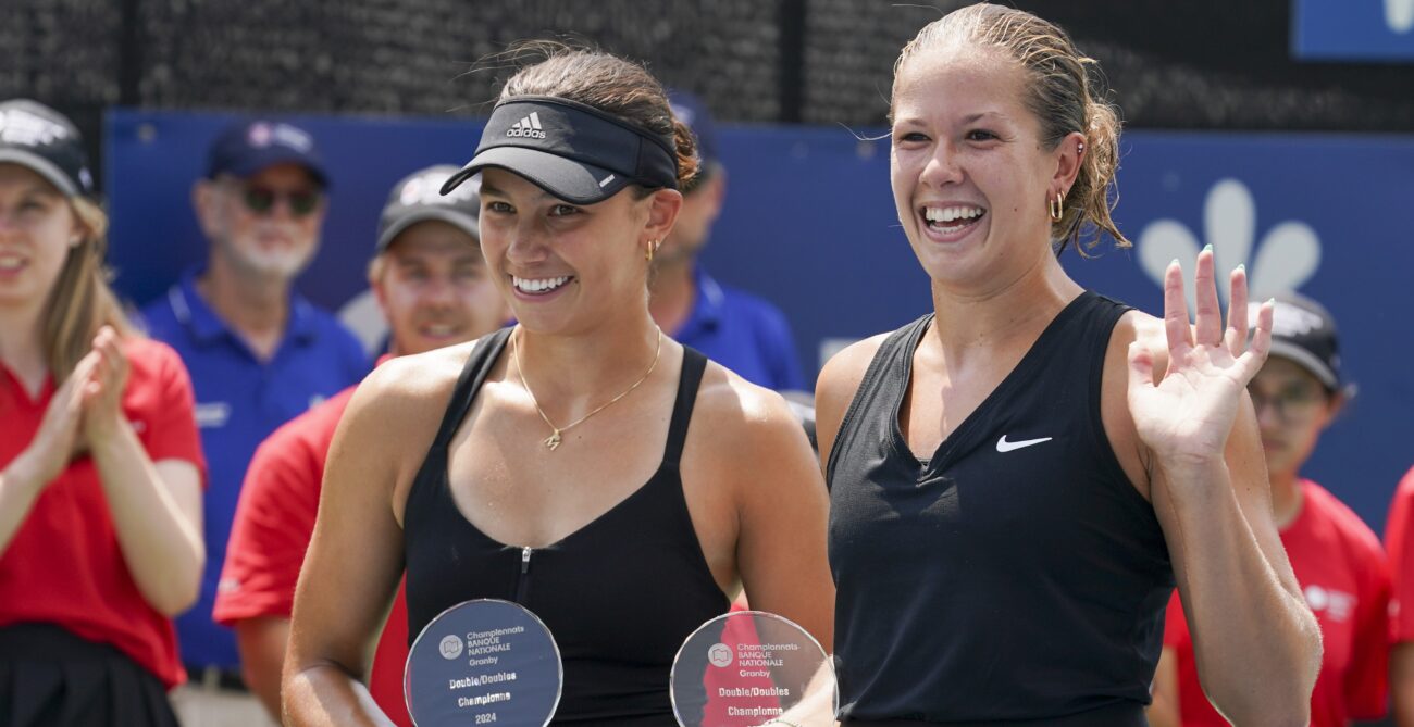 Ariana Arseneault (right) waves while Mia Kupres (left) holds her trophy in Granby.