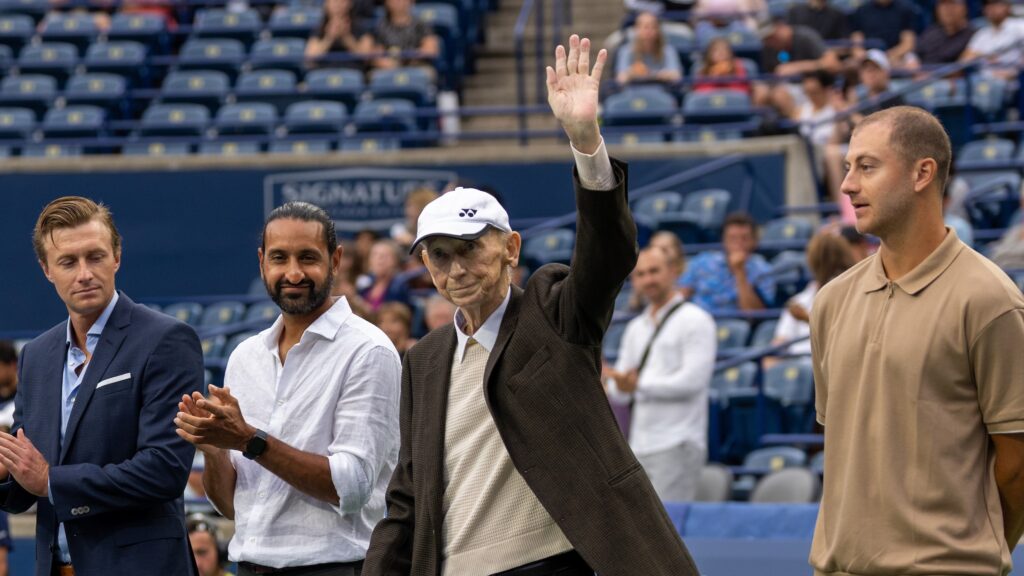 Dale Power, wearing a white cap, waves to the crowd during the Davis Cup ceremony at the 2023 National Bank Open in Toronto.