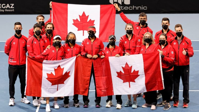 The Canadian Billie Jean King Cup team holds up Canadian flags