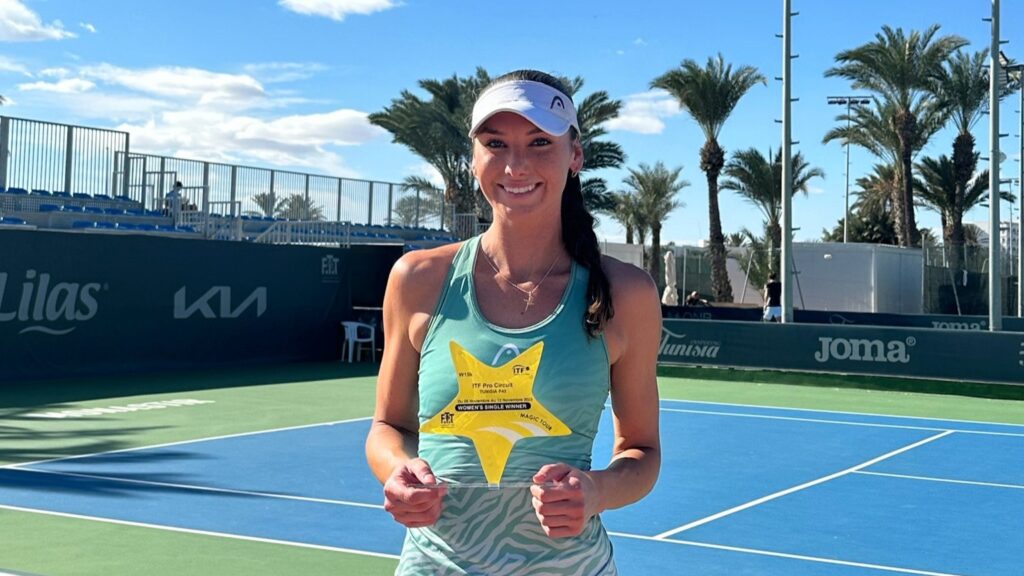 Carson Branstine holds up her trophy on court in Monastir, Tunisia.