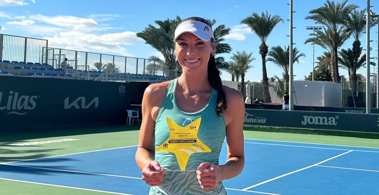 Carson Branstine holds up her trophy on court in Monastir, Tunisia.