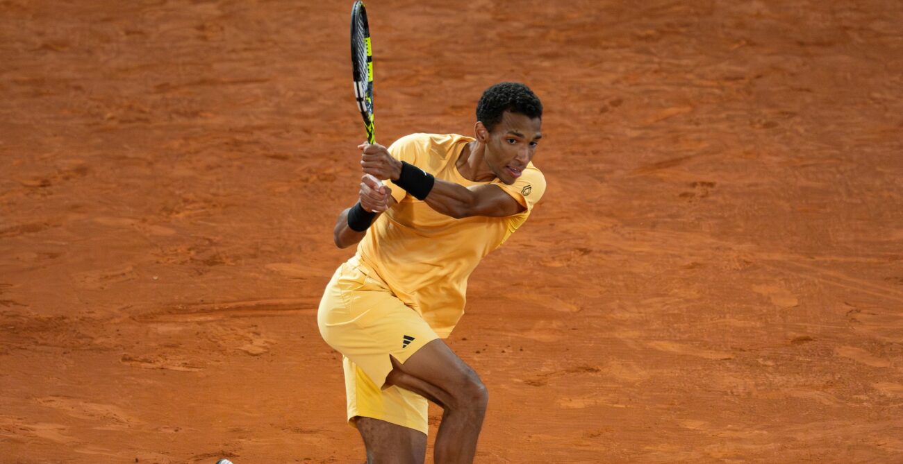 Felix Auger-Aliassime follows through on a backhand on a clay court. He played Botic van de Zandschulp in his opening match in Rome on Saturday.