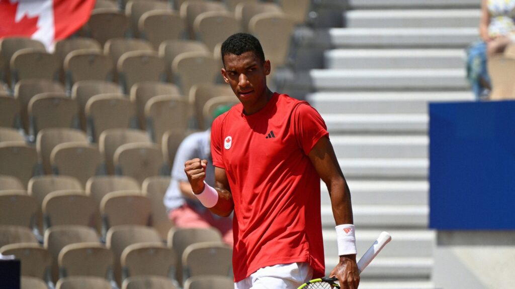 Felix Auger-Aliassime pumps his fist. He defeated Daniil Medvedev to reach the Olympic quarter-finals.