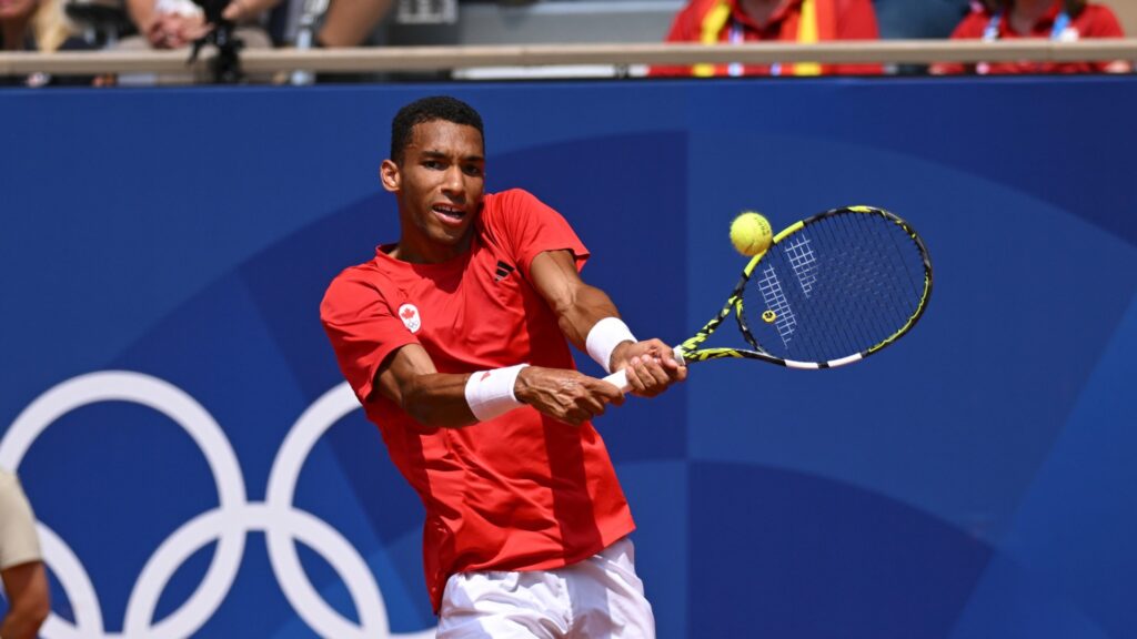 Felix Auger-Aliassime hits a backhand during his semifinal loss to Carlos Alcaraz at the Olympics.