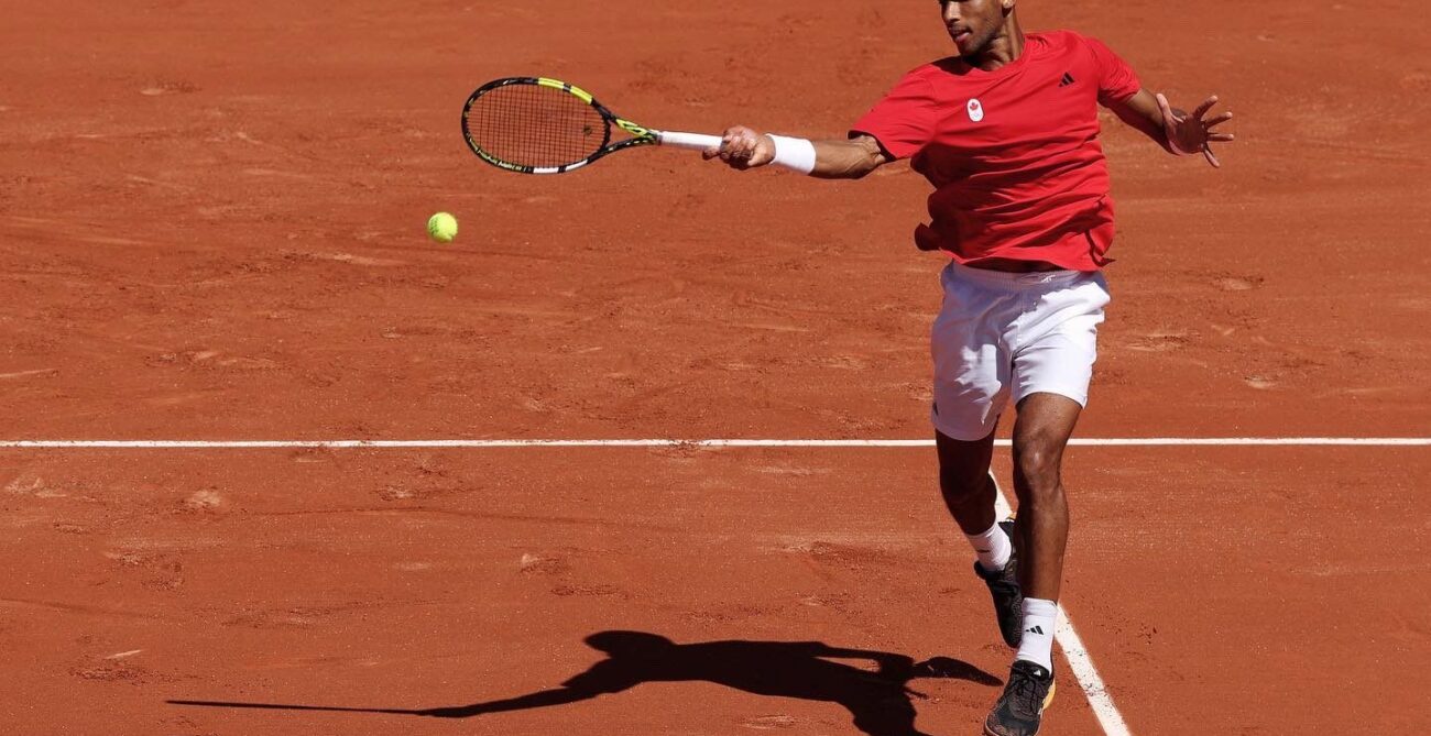 Felix Auger-Aliassime hits forehand in R1 of Paris Olympics