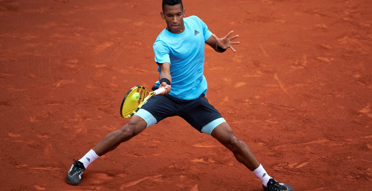 Felix Auger-Aliassime hits a forehand.