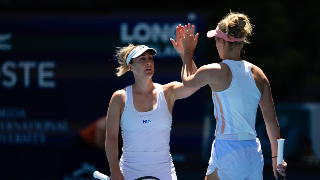 Gabriela Dabrowski (facing camera) high-fives Erin Routfliffe (back to camera) during the Miami Open final.