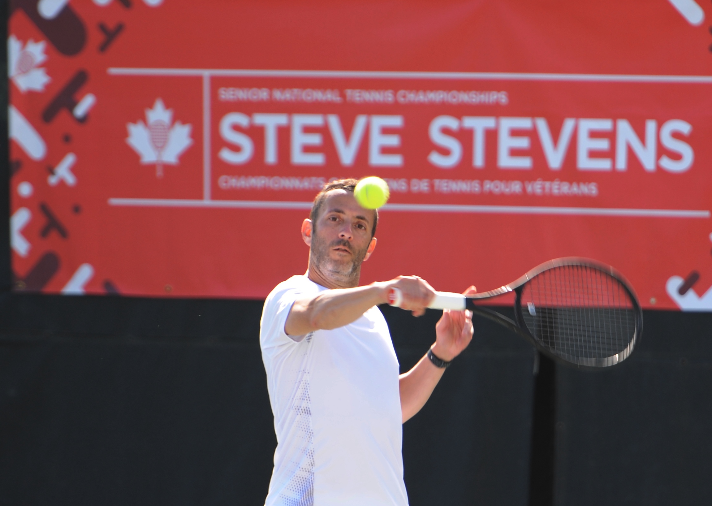 man serving tennis ball