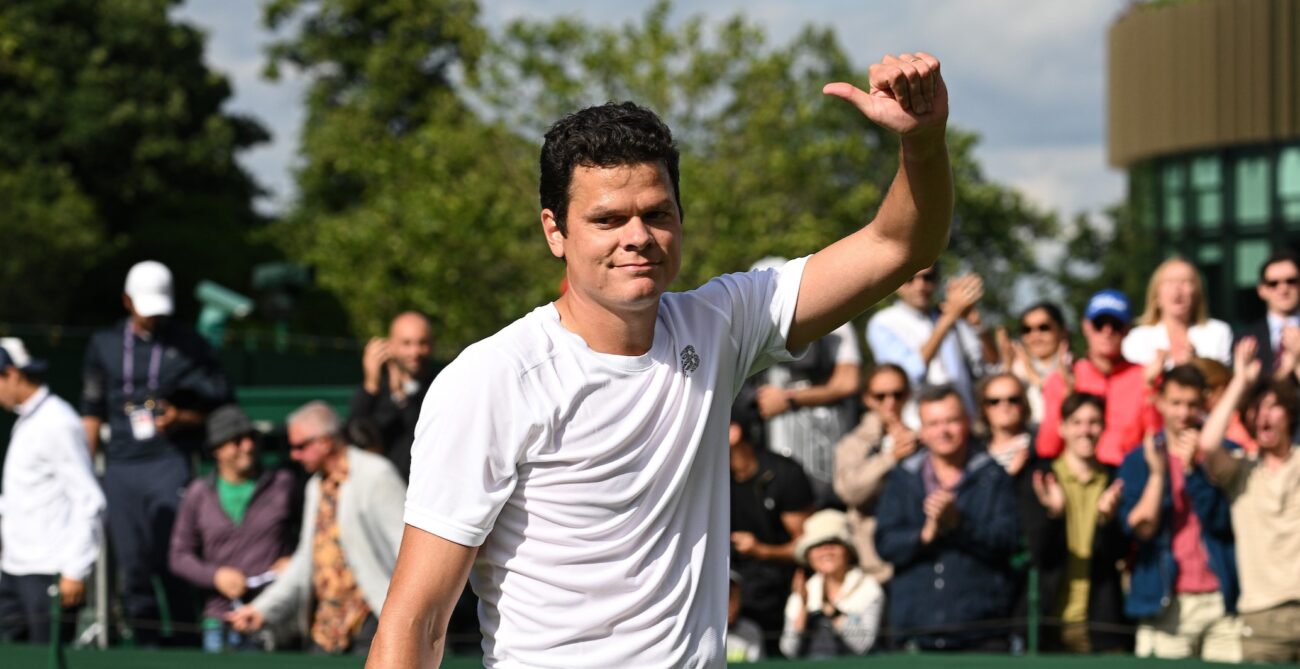 Milos Raonic gives a thumbs up to the crowd on the grass courts of Wimbledon.