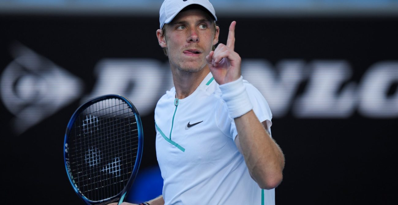 denis shapovalov holds up his finger after win