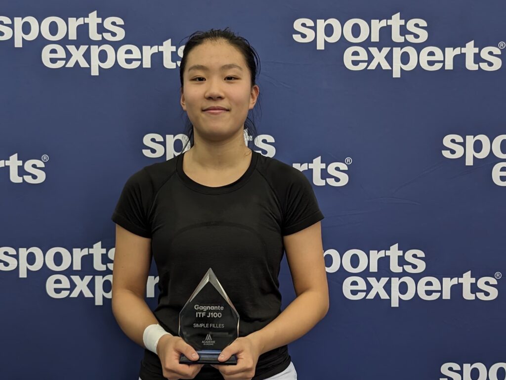 Emma Dong holds up a trophy. She and Nadia Lagaev are the top Canadians in Repentigny this week.