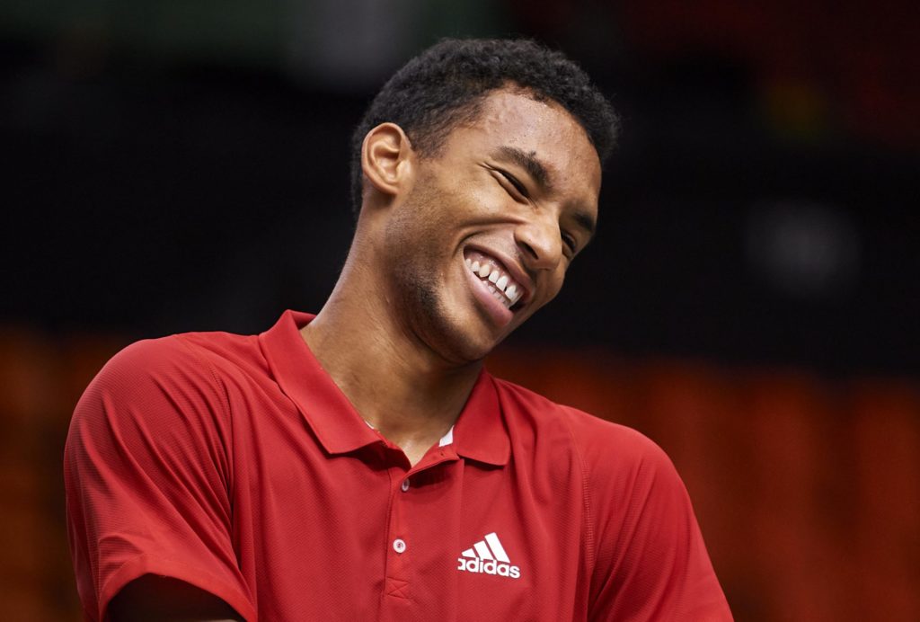 Felix Auger-Aliassime smiles during a practice