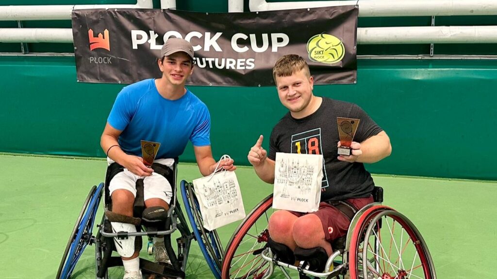 Thomas Venos (right) holds up his trophy from the ITF Wheelchair event in Plock, Poland.